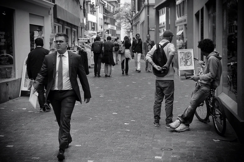 several people walking down an urban street and talking