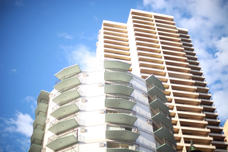 the modern building is under blue sky and clouds