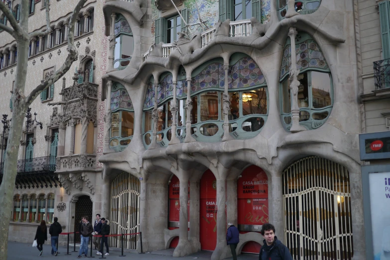 a huge building with people standing outside the door