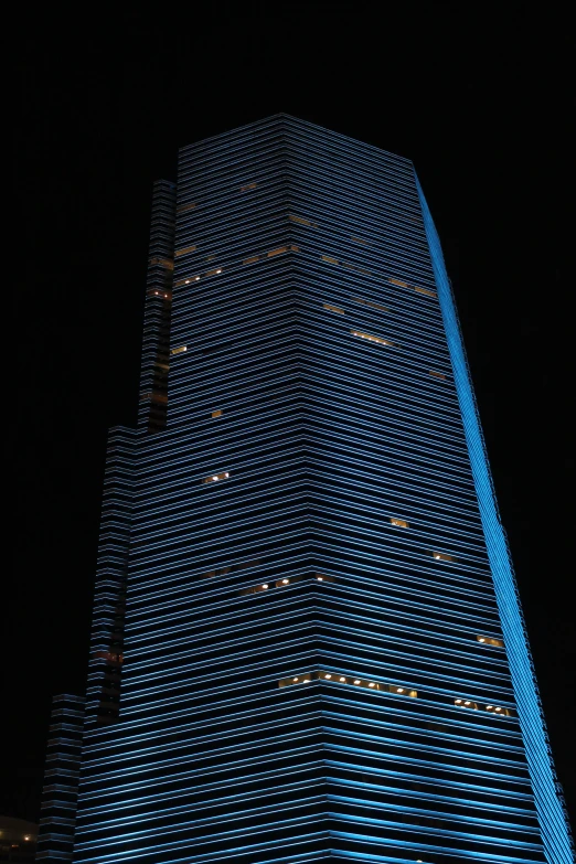 the night view of a tall building's blue light