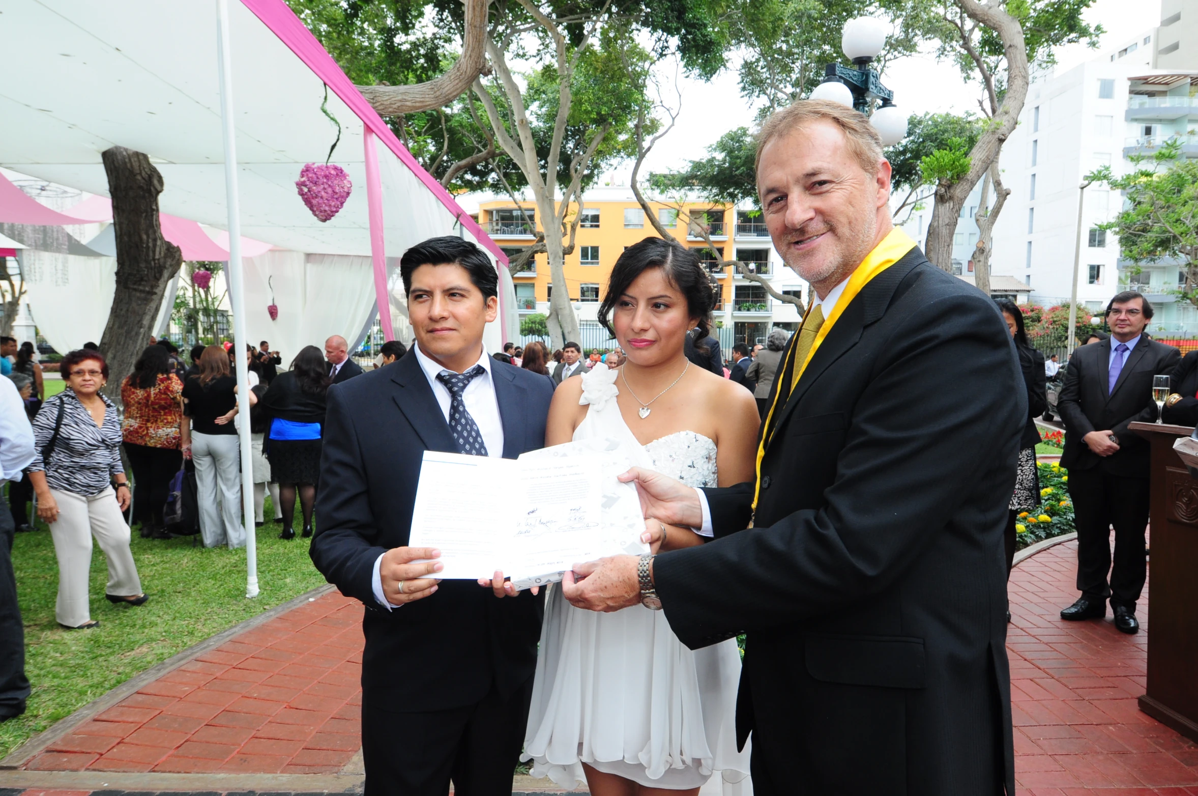 a woman, two men and a woman pose for a po with a letter