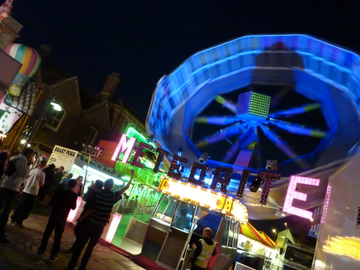 a colorful ride at night time in an amut park