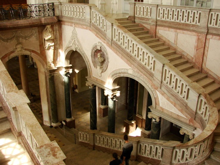 two people walking up and down some stairs