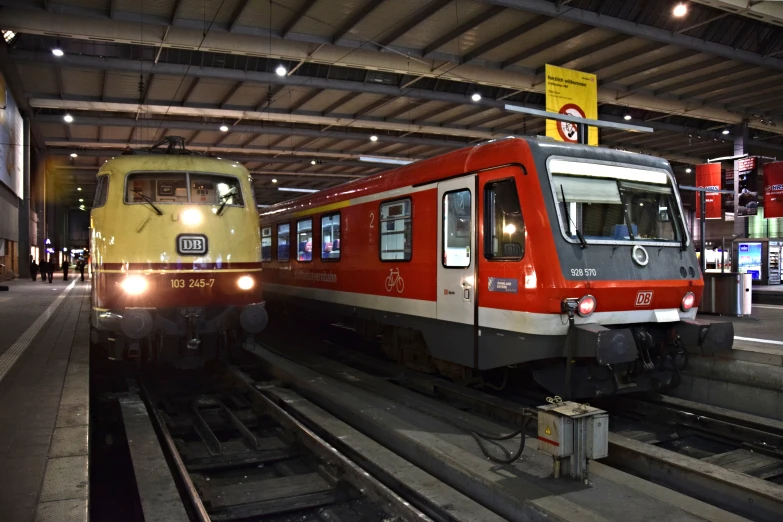 a train is stopped in a station while another stands still