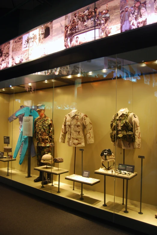 an army uniform is displayed in a store window