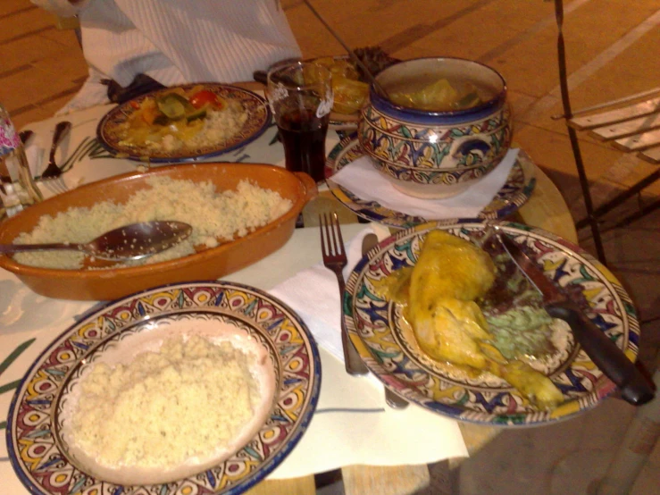 a meal served on two plates and covered with rice and meat