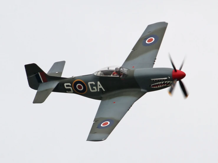 a grey military airplane is flying in the sky