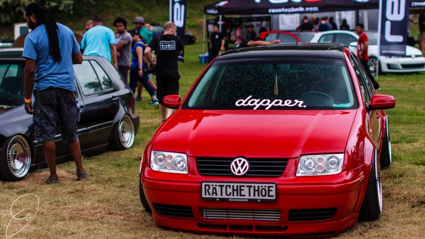 the red vw golf was on display at the car show