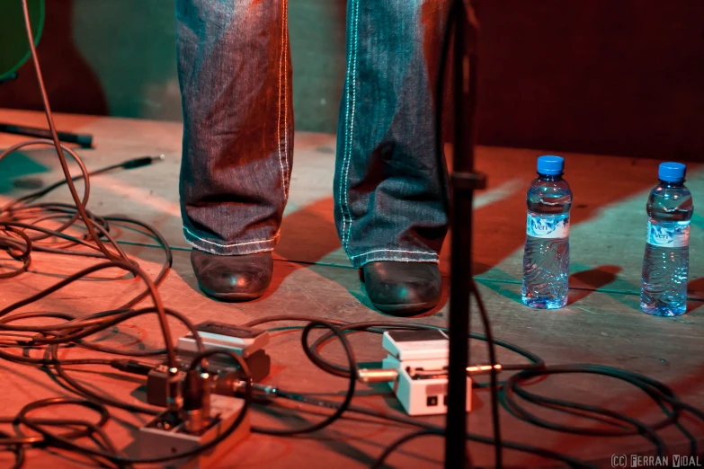 there is a person standing next to some bottles