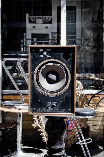 an unusual speakers sits in front of a window