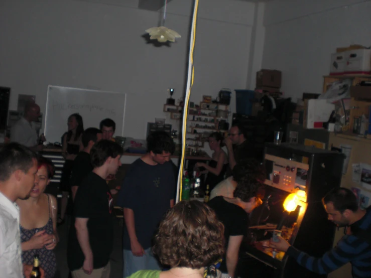 a group of people standing in a room full of cabinets