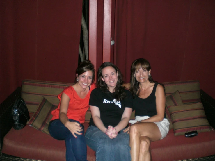 two girls sit in front of the camera while posing for a po