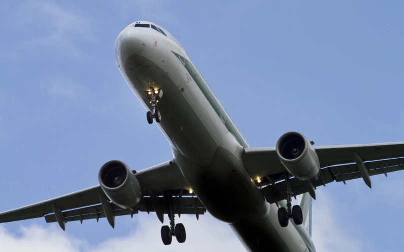 a large jetliner flying through a blue cloudy sky