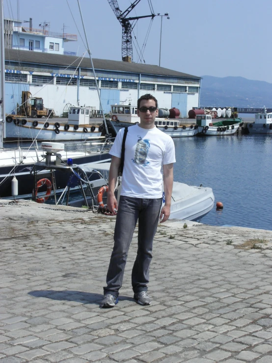 a man in front of water with buildings and boats