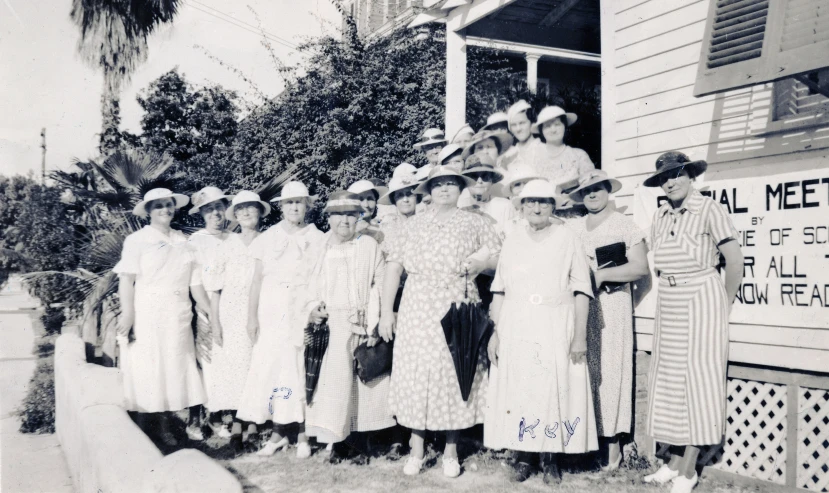 a group of women are in front of a building