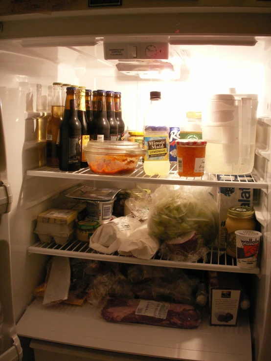 a fridge with a bunch of food inside of it