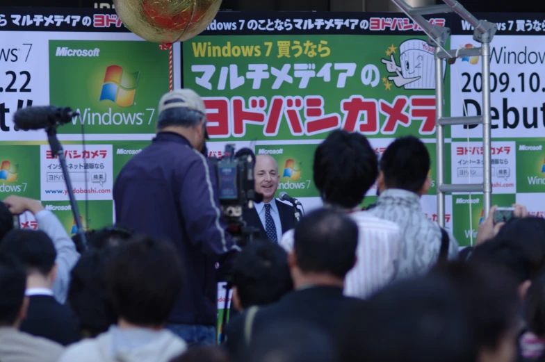 a person on stage speaking to a crowd