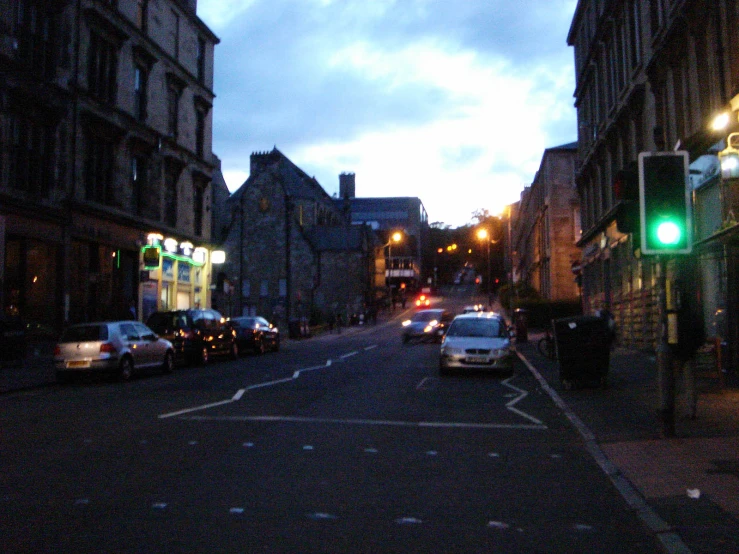 cars at dusk on a busy city street