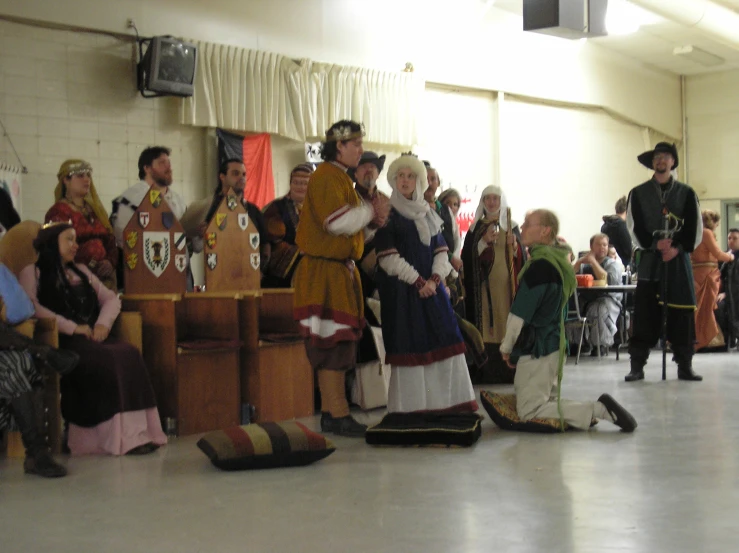 a group of people in medieval costumes standing around