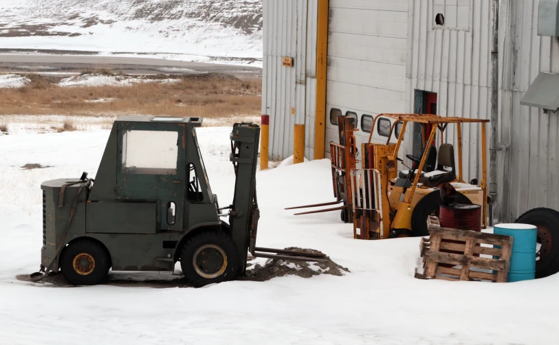 an old utility vehicle parked in the snow