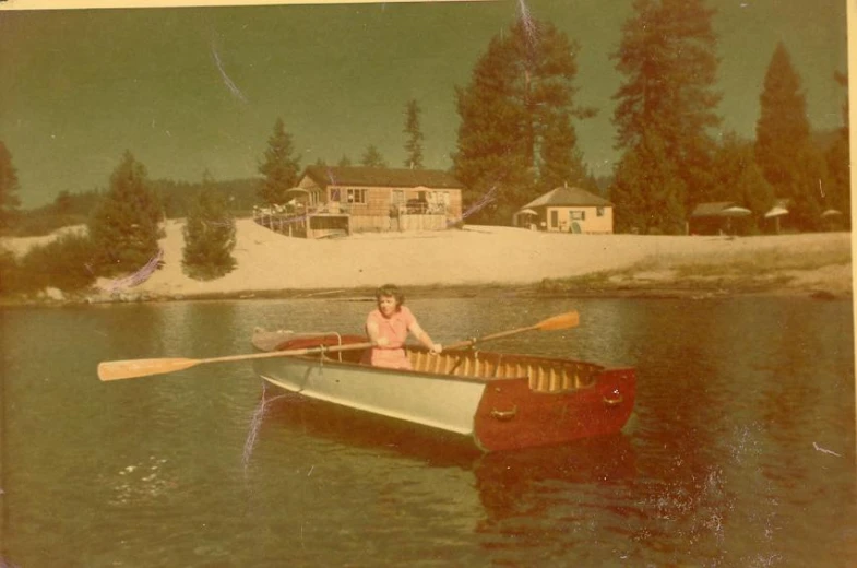 a woman sitting in a small boat on the water