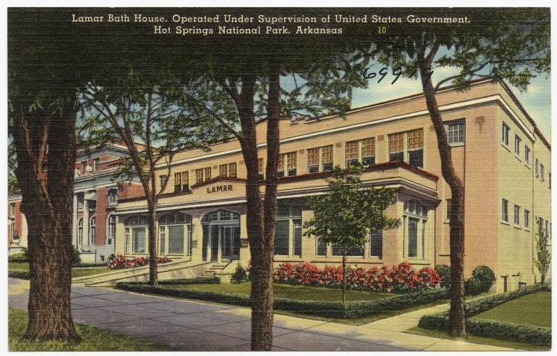 an old postcard depicts a building at the end of the street