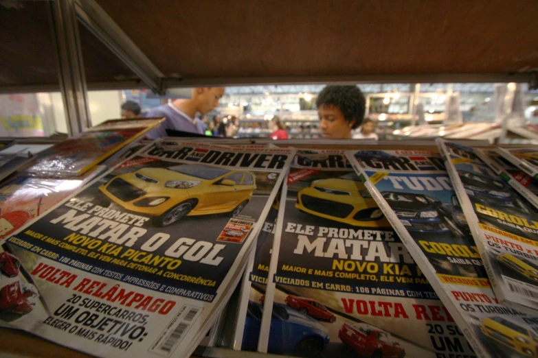 newspapers stacked together on top of each other in front of a store window