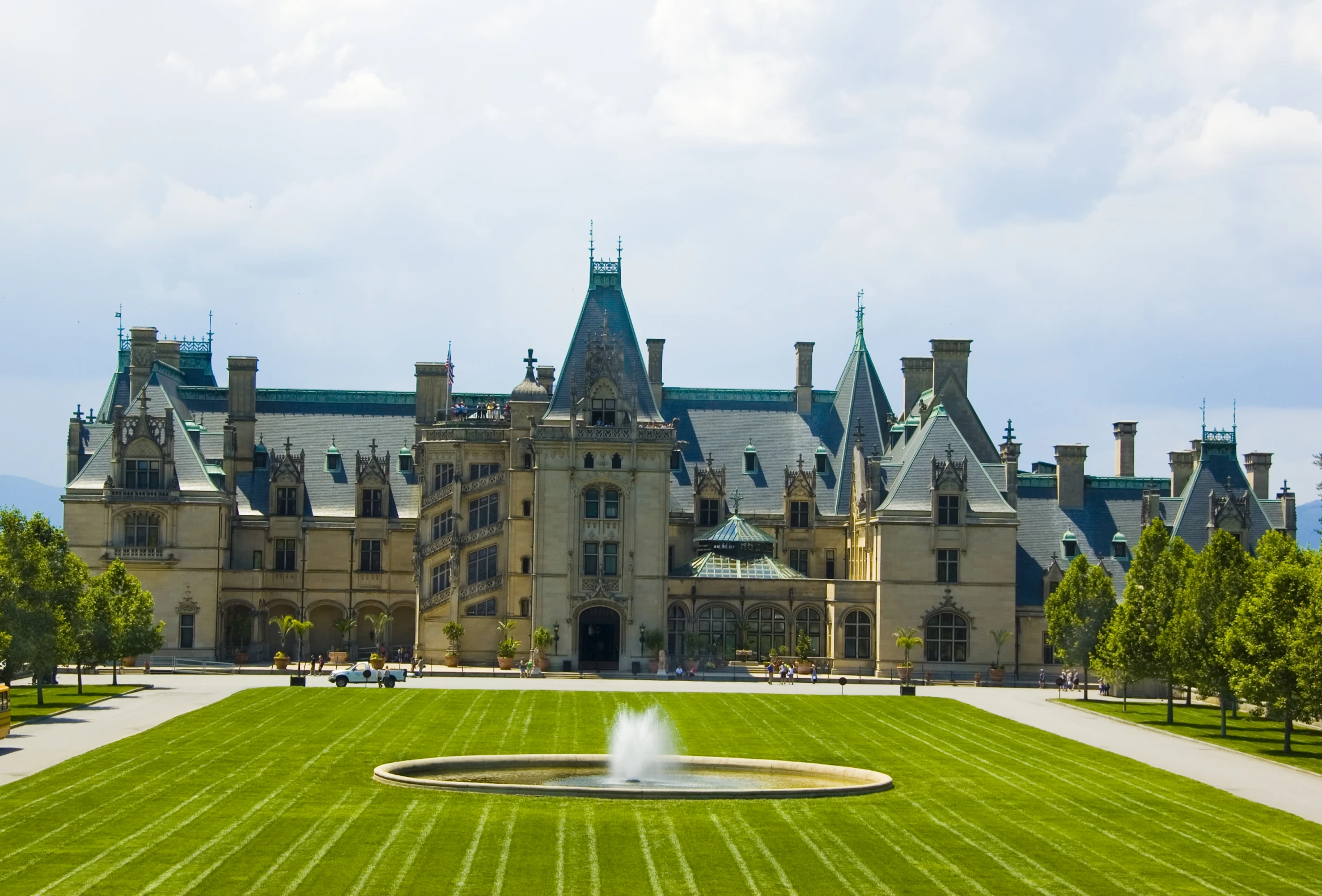 a large brown building with a fountain inside of it