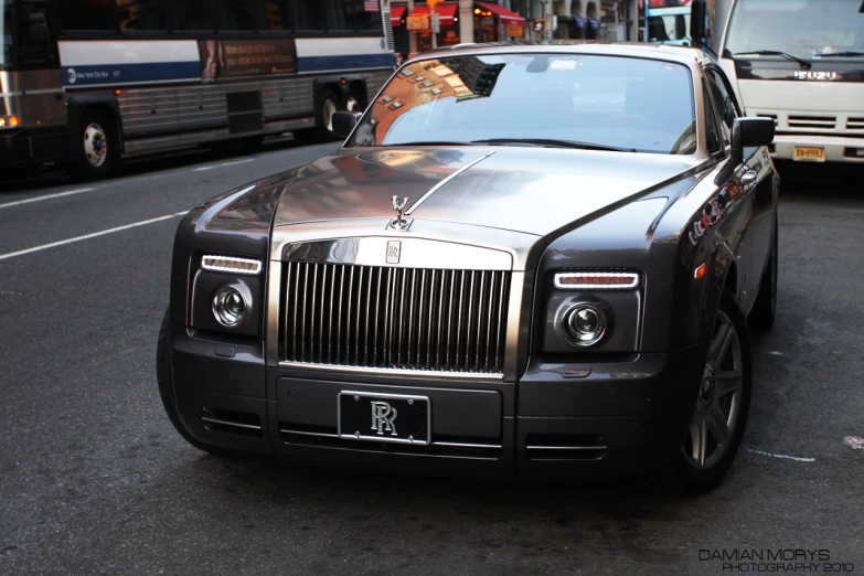a black rolls royce parked in a parking space