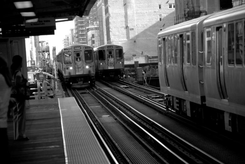 two trains on tracks in a train station