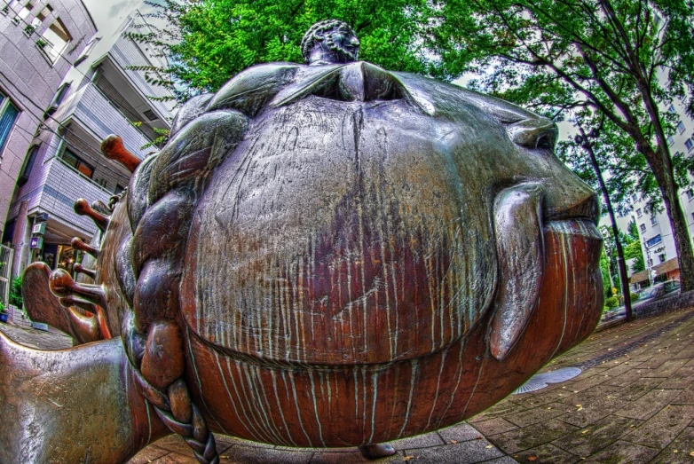 a bronze statue is placed in the middle of a courtyard