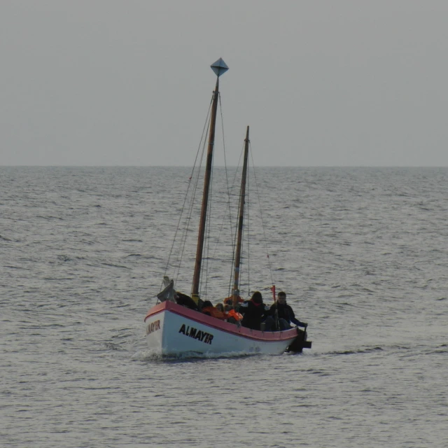 a small sailboat floating on a body of water