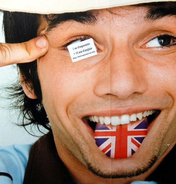 a man has his fingers painted to say british on his tongue
