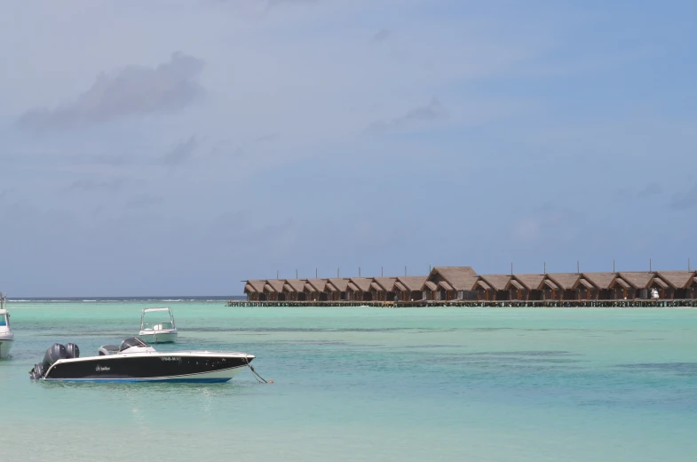 a boat sits in the shallow water next to houses