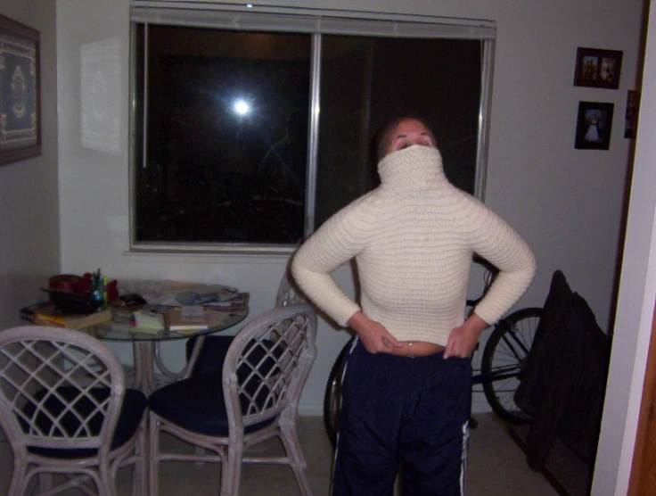 a person standing in front of a table and chairs