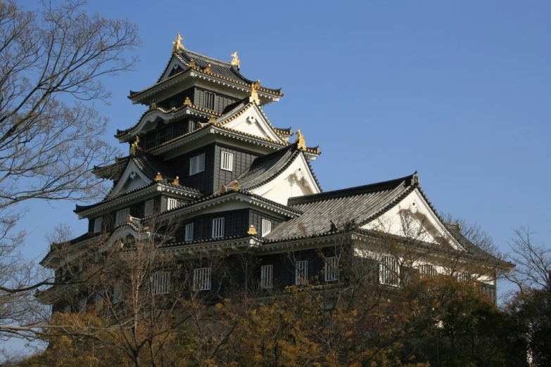 a very tall building with a roof and some trees