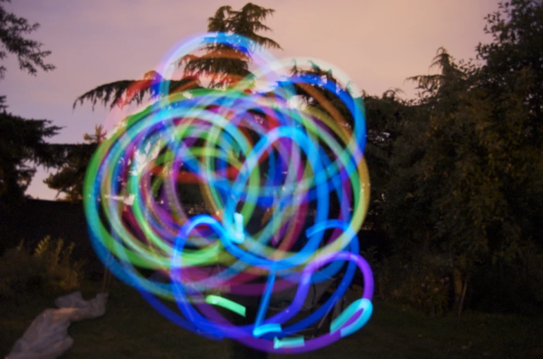 colorful lights spinning around in front of a building