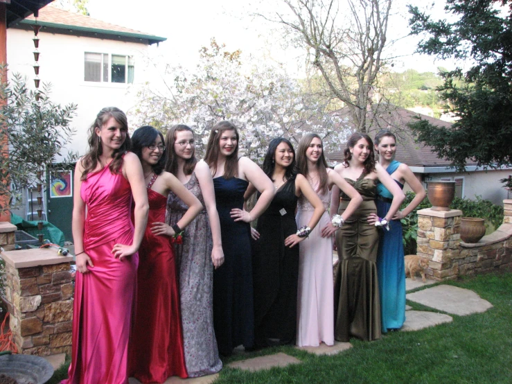 a group of women posing in formal wear