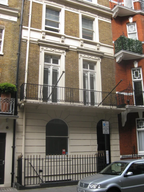 an old fashion apartment building with iron railings and balconies on each of the buildings