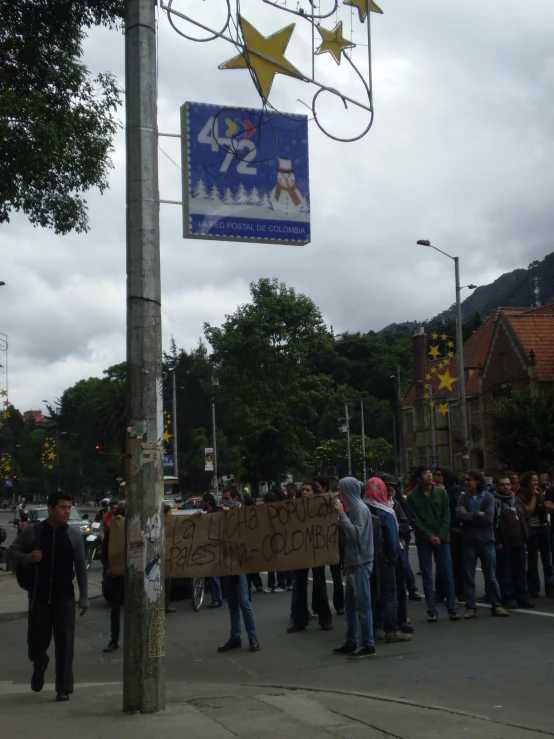 many people holding signs protesting with one man wearing a star