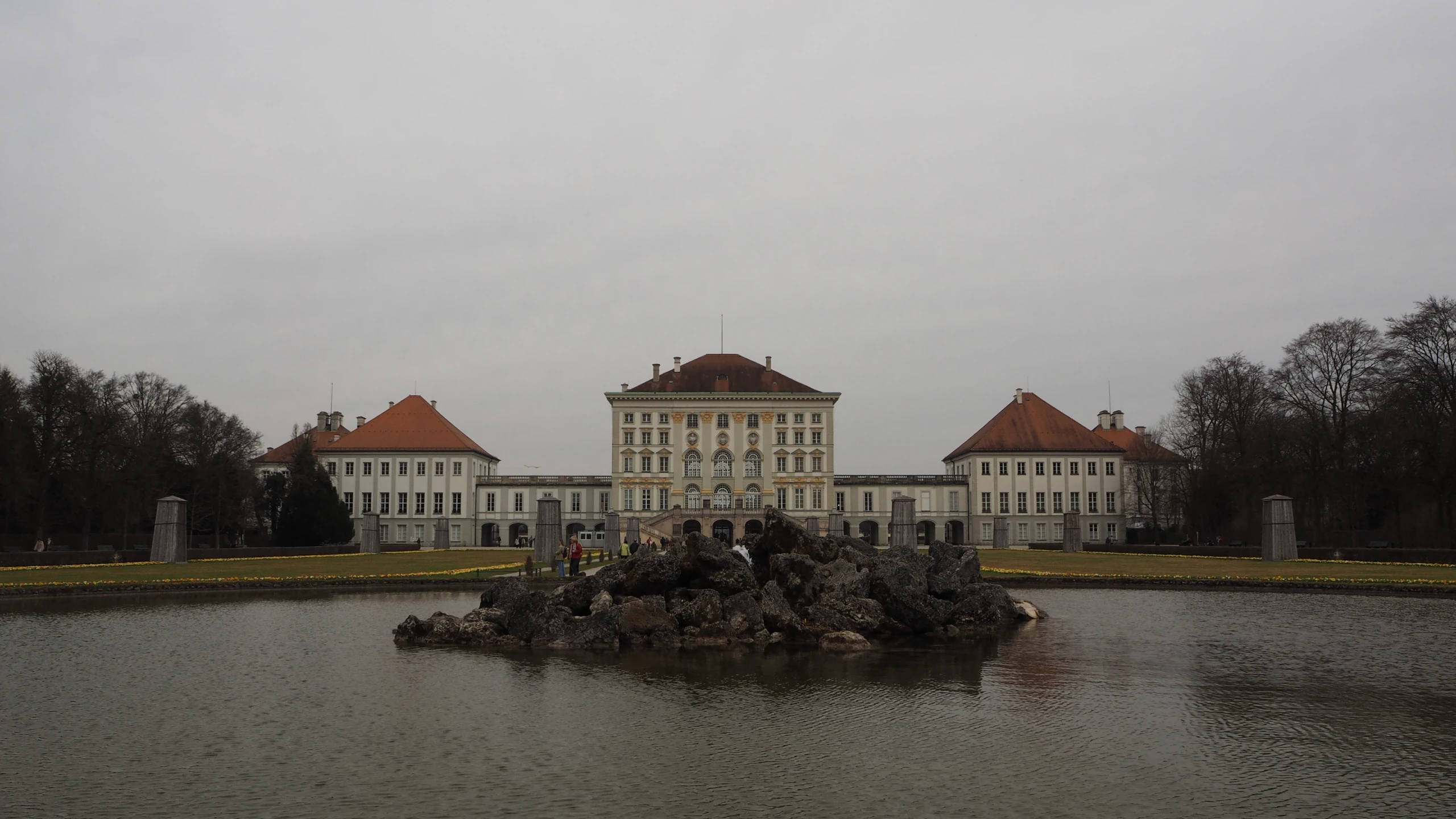 two large white building and a body of water