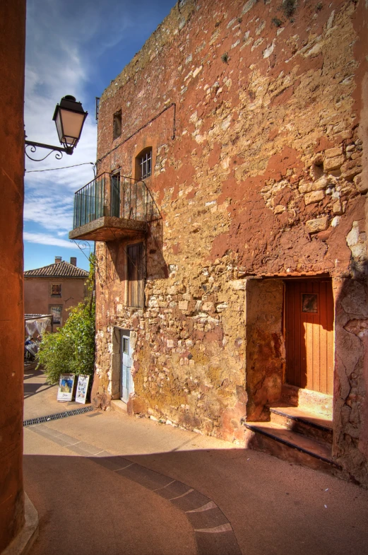 old brick building on a city street corner with a lantern