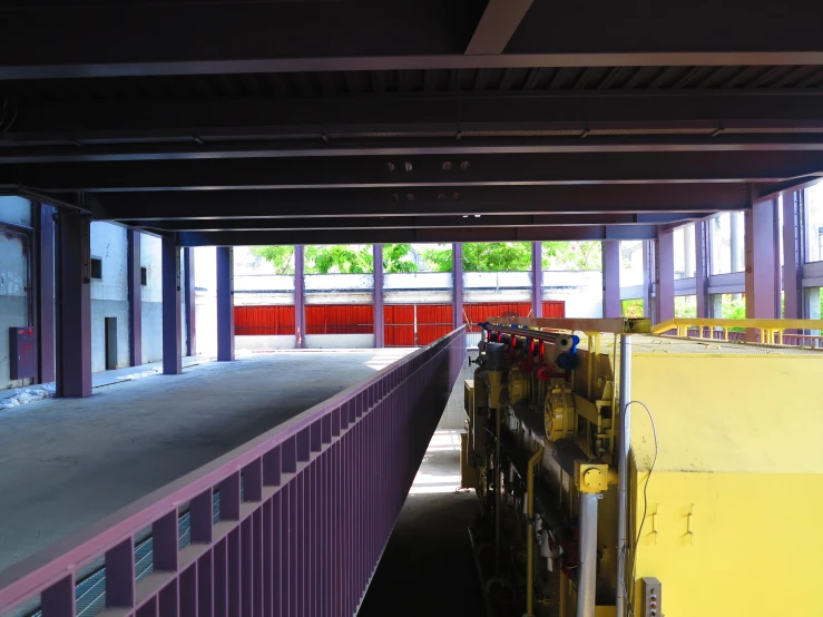 a room with lots of glass windows and purple barriers