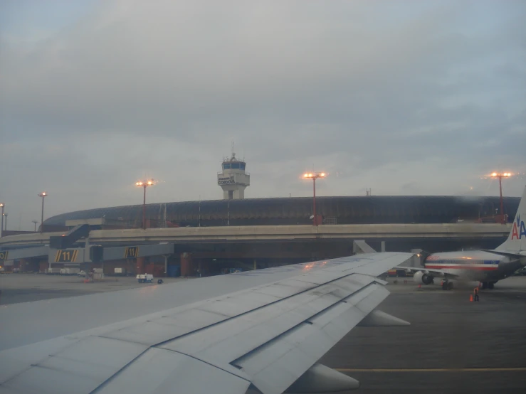 a passenger jet flying over an airport with its stairs open