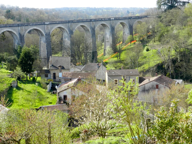 a train traveling over an old stone bridge