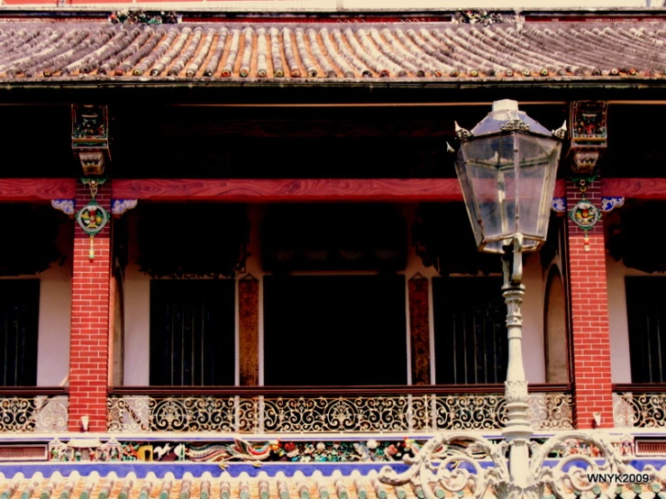 an ornate balcony of a building with a light on it