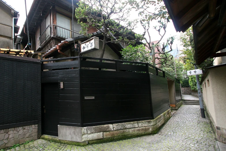 the black fence surrounds the back of this building