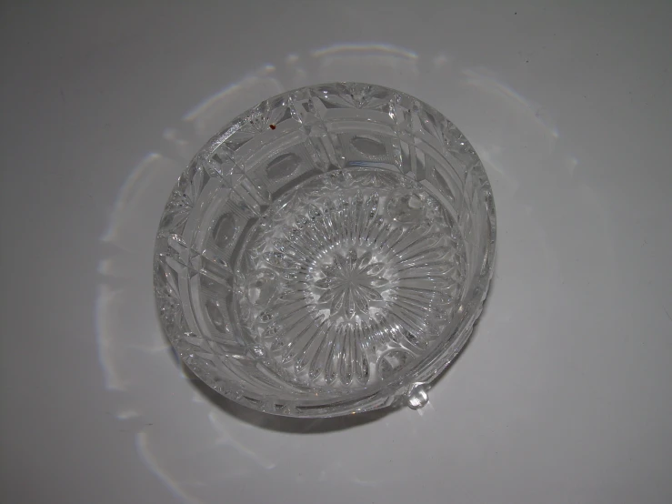 a clear glass bowl that is on a table