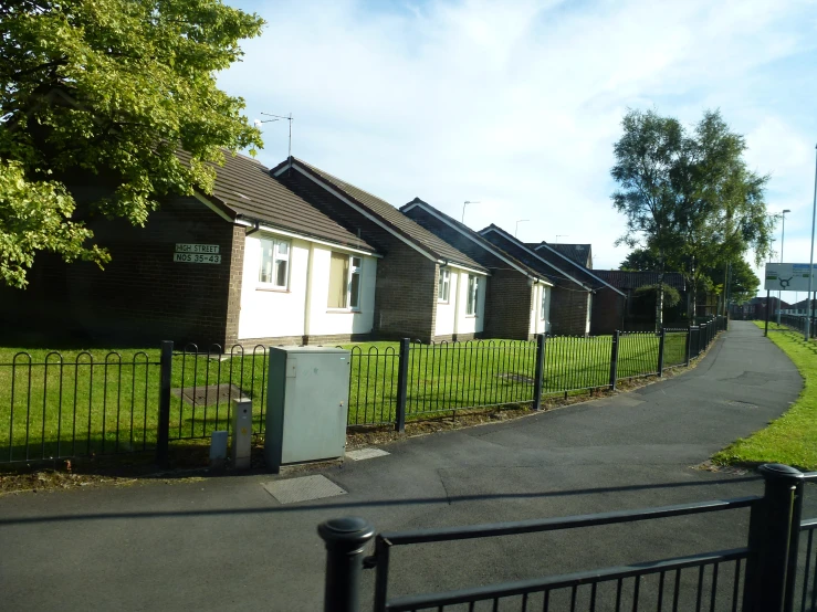 two houses near a fence next to each other