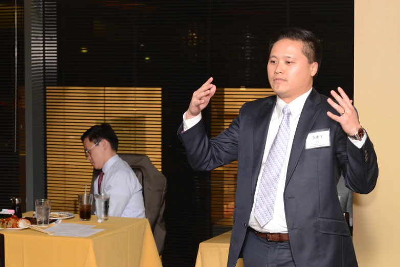 a man stands and gives a presentation at an event